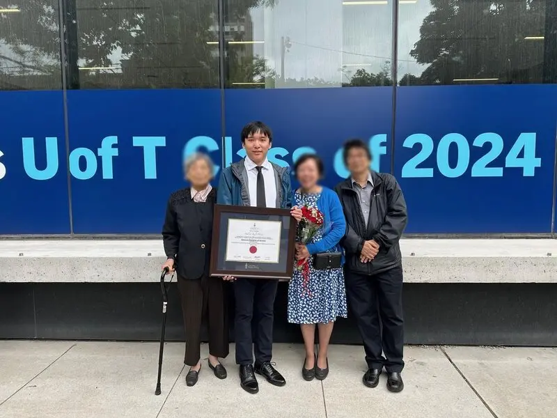 My grandmother, parents and I after convocation (blurred for privacy)